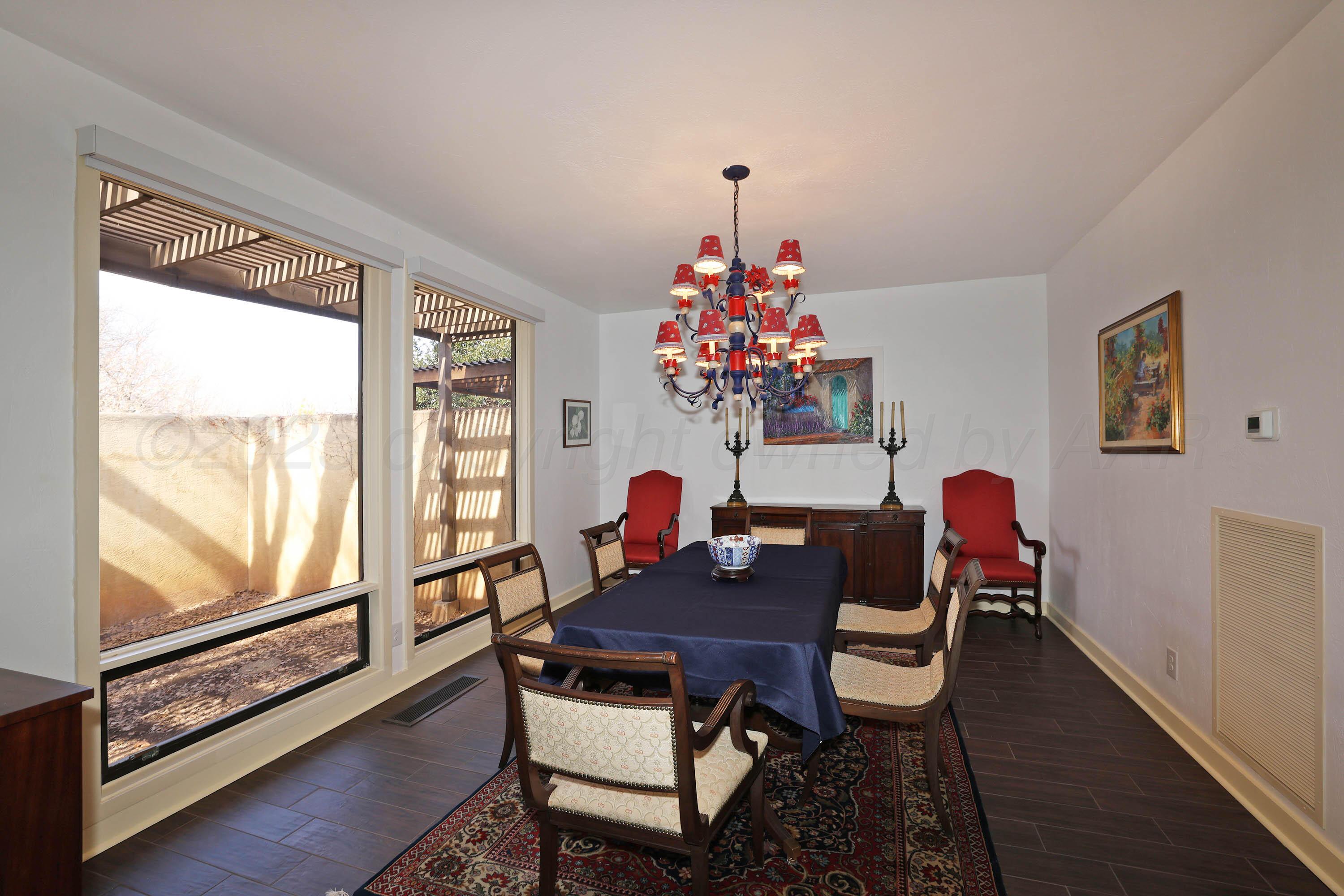6 Woodstone Street Amarillo, TX 79106 - Photo 11 of 35 a view of a dining room with furniture window and wooden floor