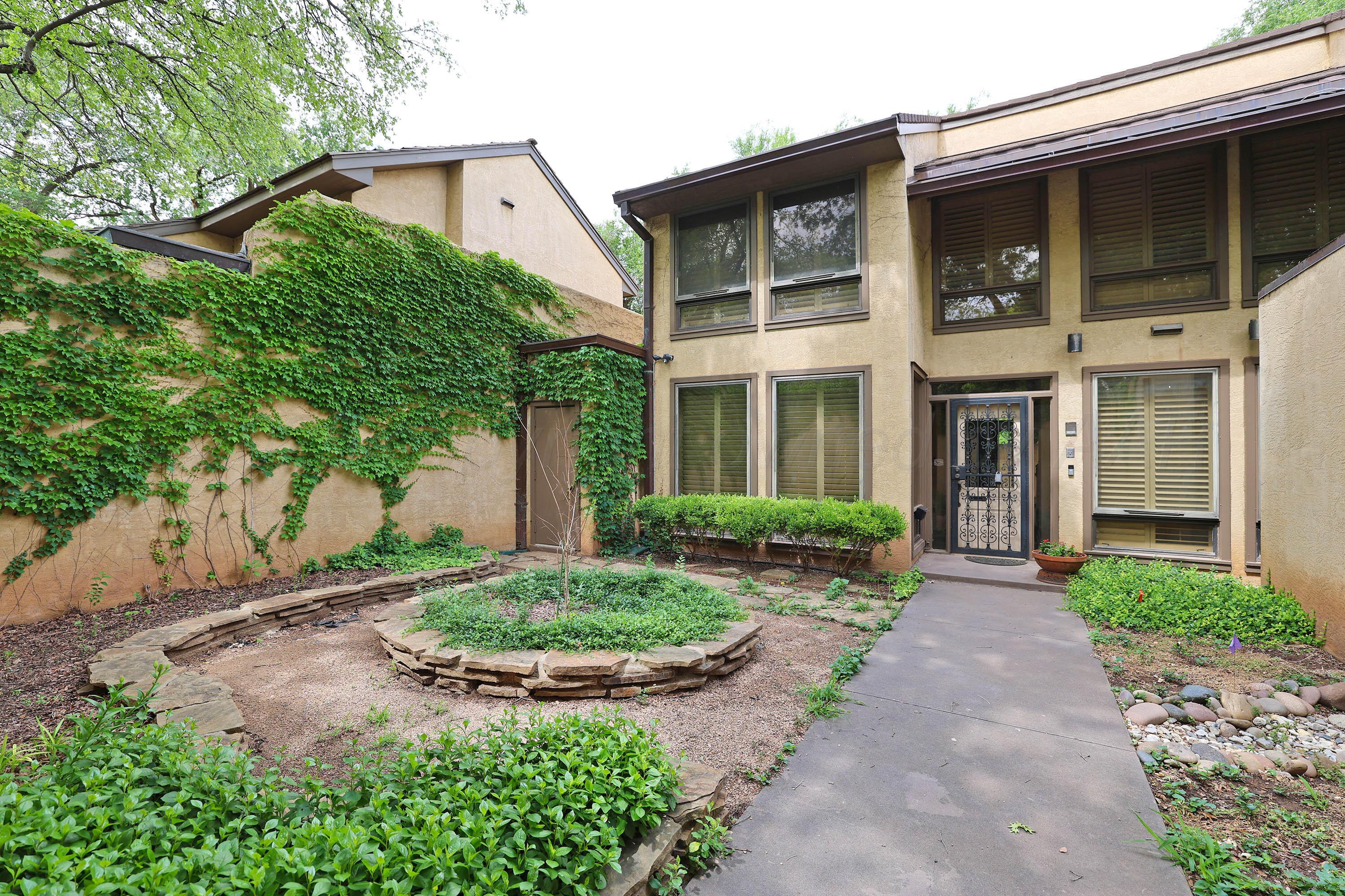 6 Woodstone Street Amarillo, TX 79106 - Photo 3 of 35 a front view of a house with garden and lots of trees