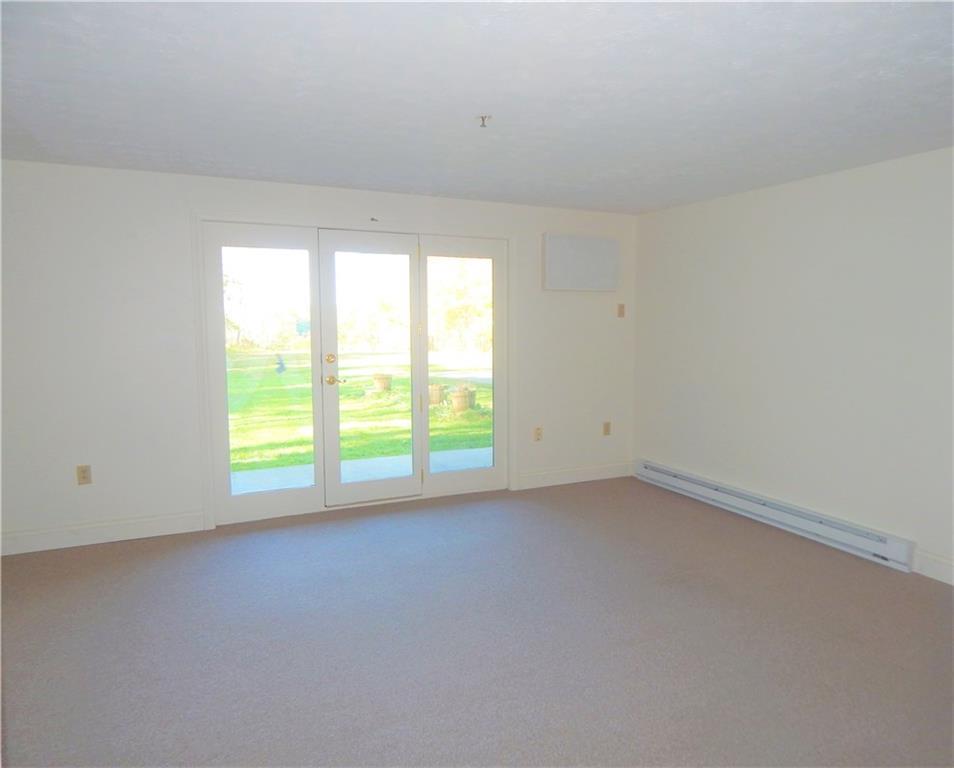 574 Main Street, Unit 101 Damariscotta, ME 04543 - Photo 15 of 34 Living room with walkout to the...