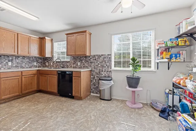 a kitchen with a sink cabinets and window
