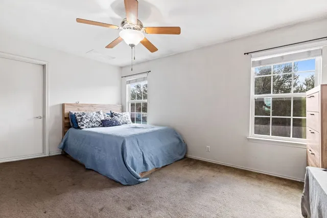 a spacious bedroom with a bed and window