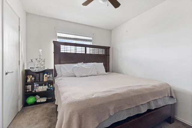 a bedroom with a bed and a window