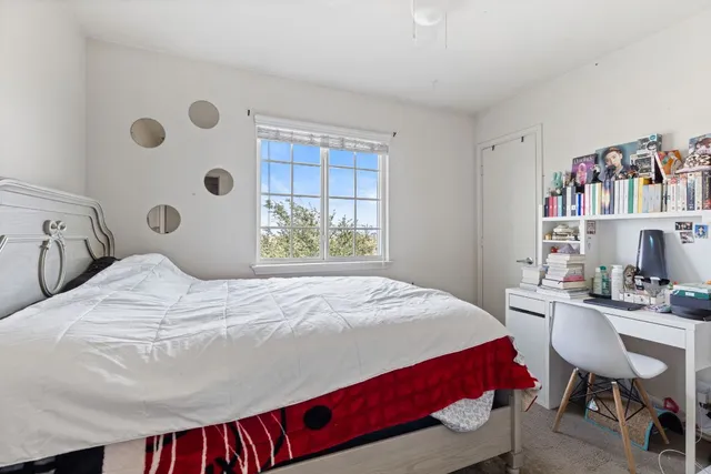 a bedroom with a bed and a bookshelf
