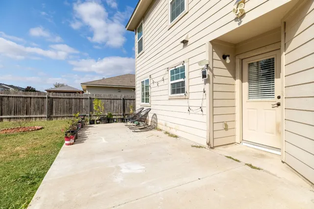 a view of a house with backyard and sitting area