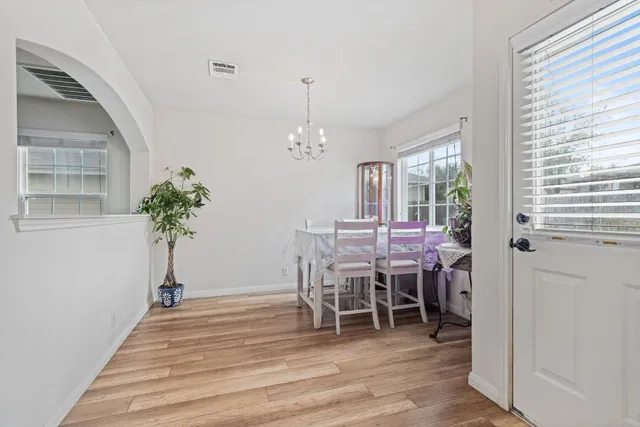 a view of a dining room with furniture window and wooden floor