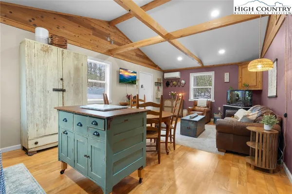 a kitchen with furniture a counter top space a sink stainless steel appliances and cabinets