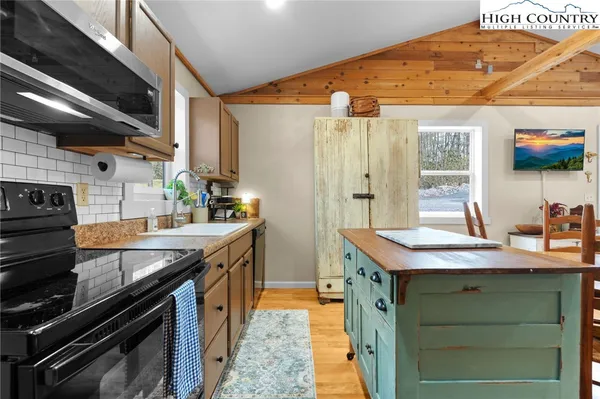 a kitchen with stainless steel appliances granite countertop a sink and a stove
