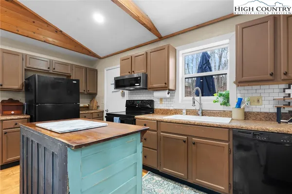 a kitchen with a sink appliances and cabinets
