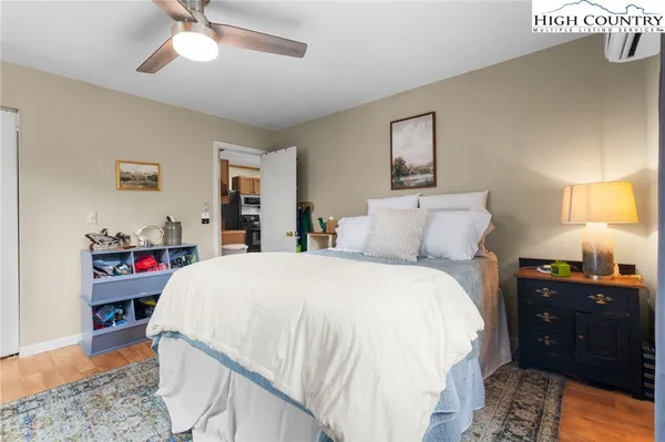 a bedroom with a bed dresser and a window