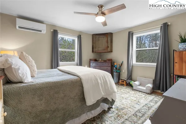 a bathroom with a granite countertop toilet a sink and a mirror