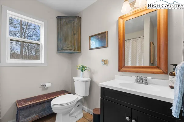 a white toilet sitting next to a shower curtain