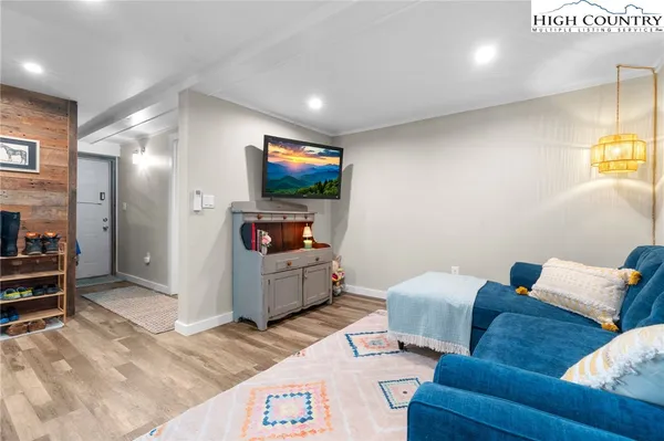 a living room with furniture and a flat screen tv