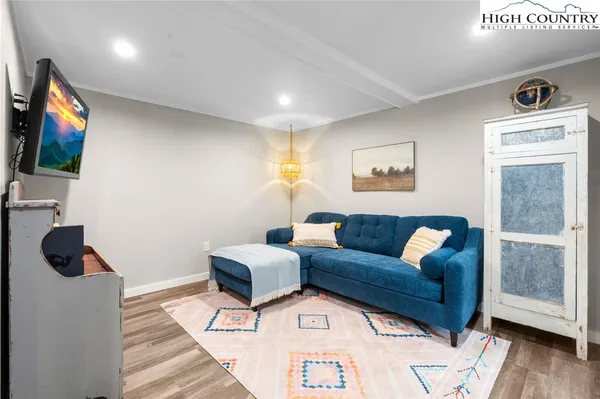 a living room with furniture and a book shelf