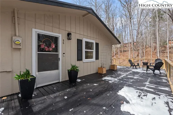 a backyard of a house with table and chairs