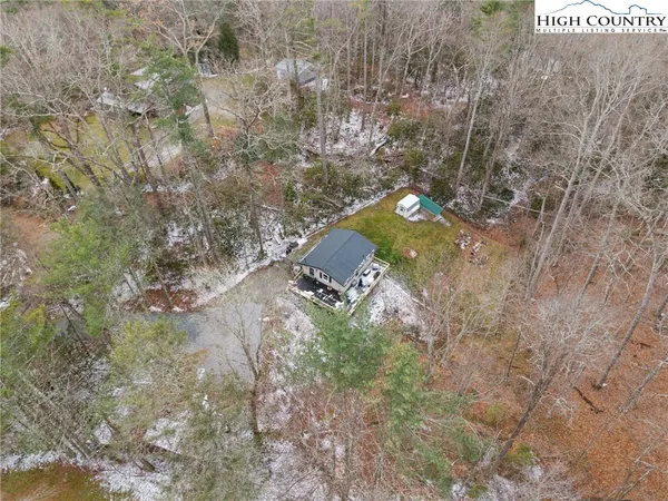 a view of a dry field with mountains in the background