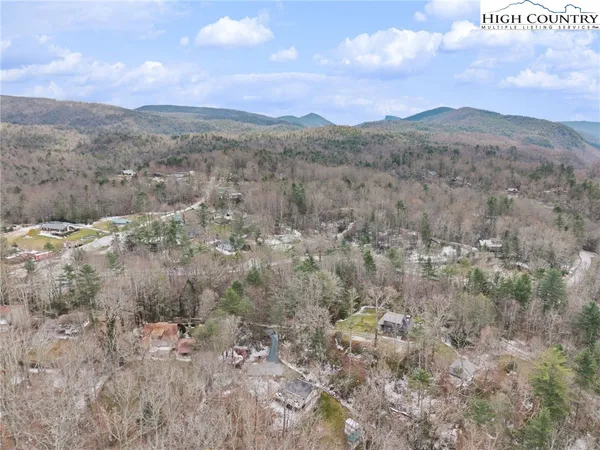 a view of backyard with wooden fence