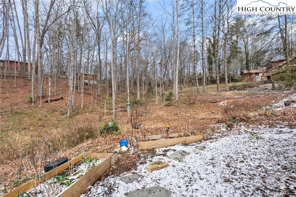 a view of a balcony with chairs and wooden fence