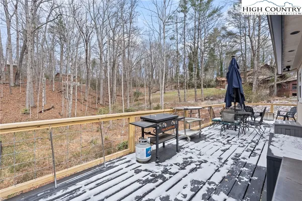 a view of balcony with wooden floor and outdoor seating