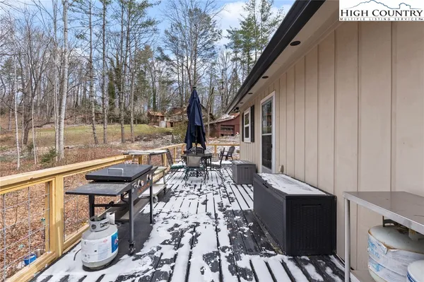 a backyard of a house with a garden and barbeque oven