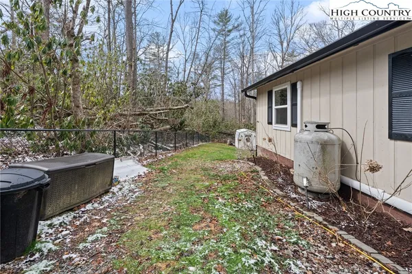 a view of a house with a yard covered in snow