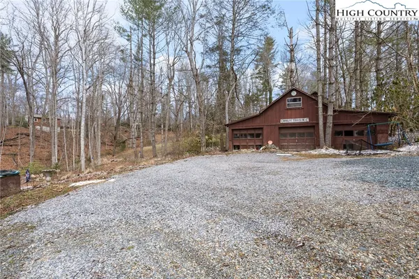 a view of a yard with large trees