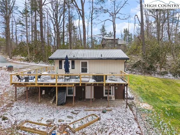a view of a patio with table and chairs under an umbrella