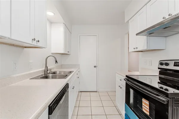 a kitchen with a sink appliances and cabinets