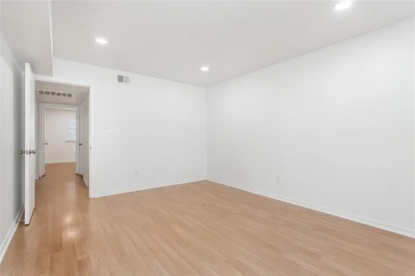 a view of hallway with wooden floor