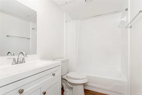 a bathroom with a sink a toilet and shower