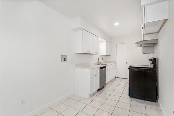 a kitchen with a stove a sink and a refrigerator