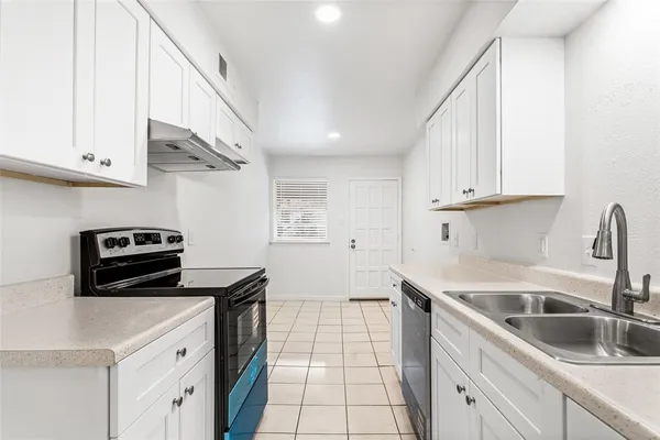 a kitchen with a sink and cabinets
