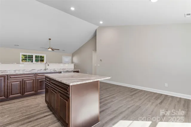 a kitchen with a stove top oven sink and cabinets