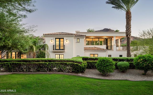 a bedroom with a large bed couch and a window