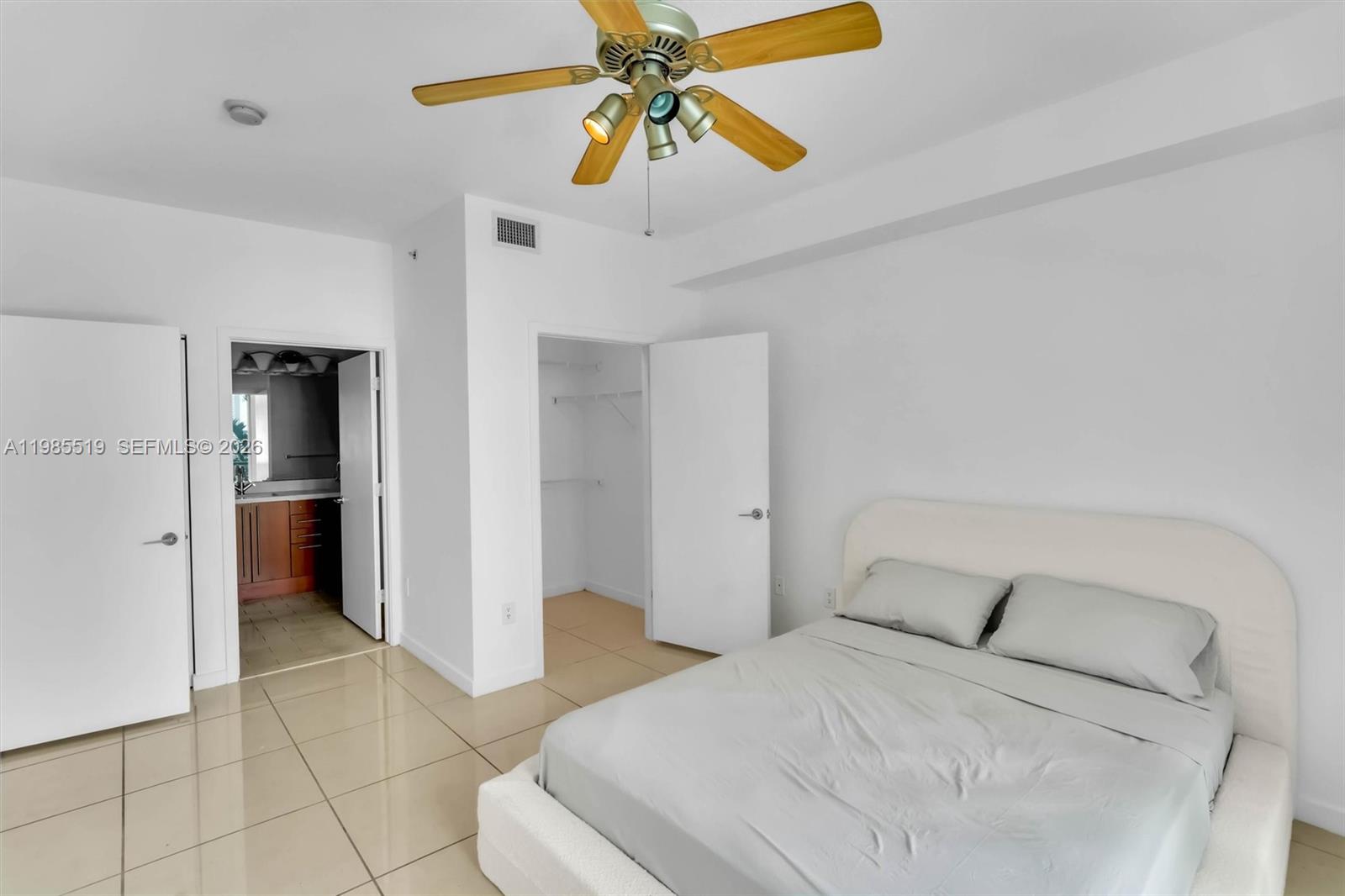 79 Southwest 12th Street, Unit 1210 Miami, FL 33130 - Photo 11 of 37 a bedroom with a bed and a chandelier