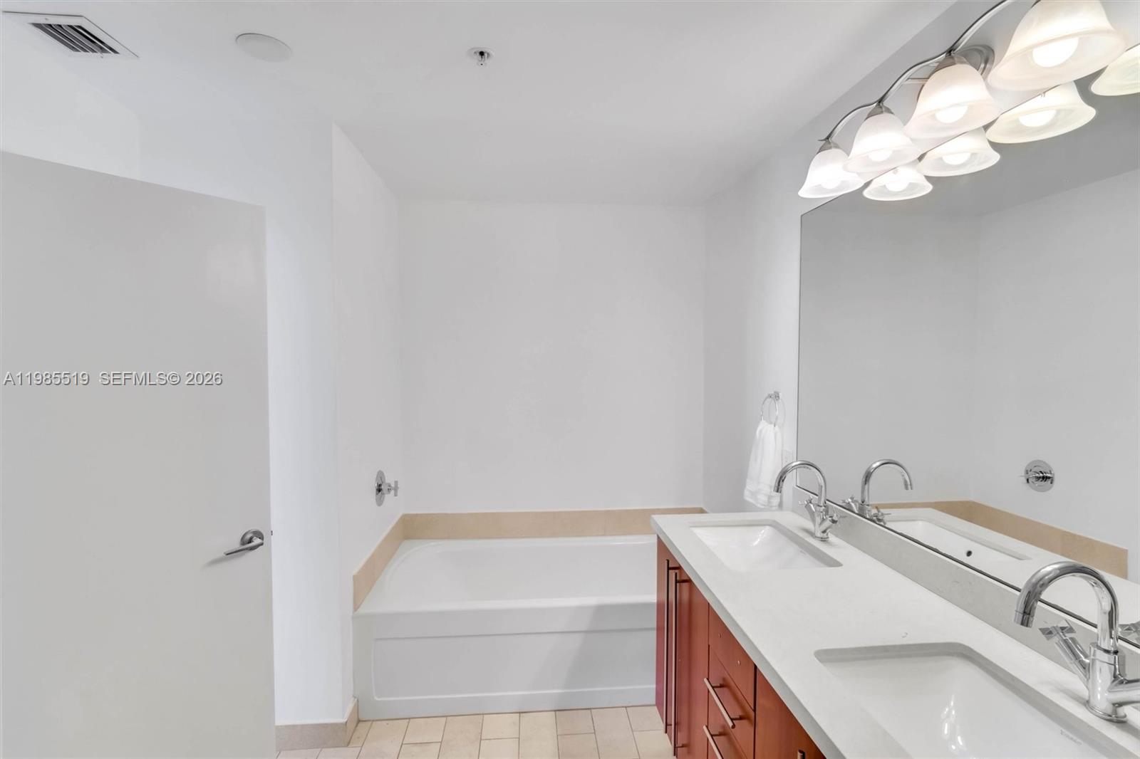 79 Southwest 12th Street, Unit 1210 Miami, FL 33130 - Photo 14 of 37 a bathroom with a sink and a bathtub