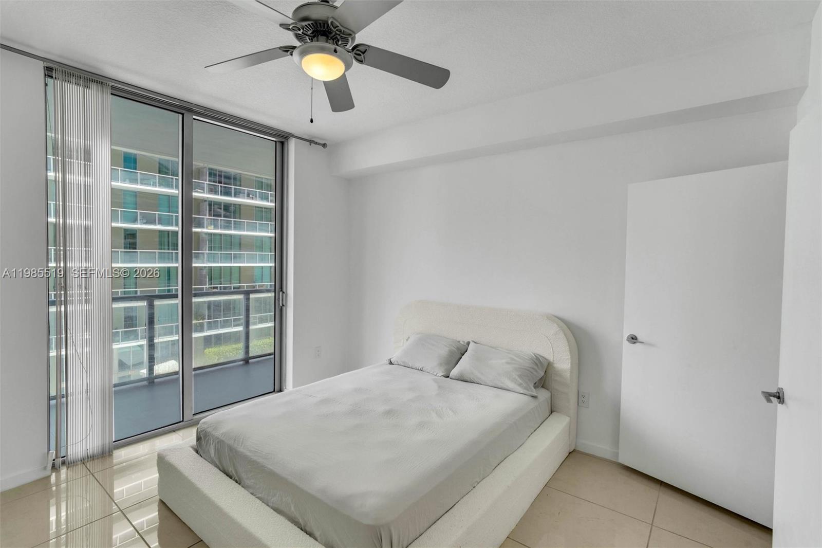 79 Southwest 12th Street, Unit 1210 Miami, FL 33130 - Photo 16 of 37 a bedroom with a bed and a chandelier