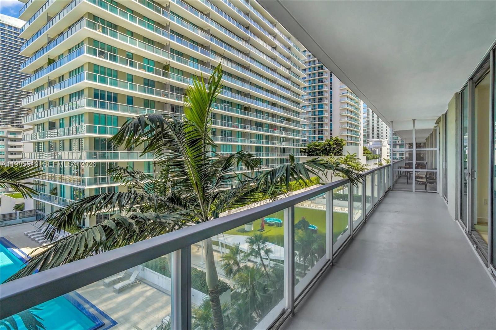 79 Southwest 12th Street, Unit 1210 Miami, FL 33130 - Photo 21 of 37 a view of a balcony with wooden floor and fence
