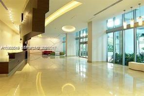 79 Southwest 12th Street, Unit 1210 Miami, FL 33130 - Photo 36 of 37 a swimming pool with a large window and painted walls