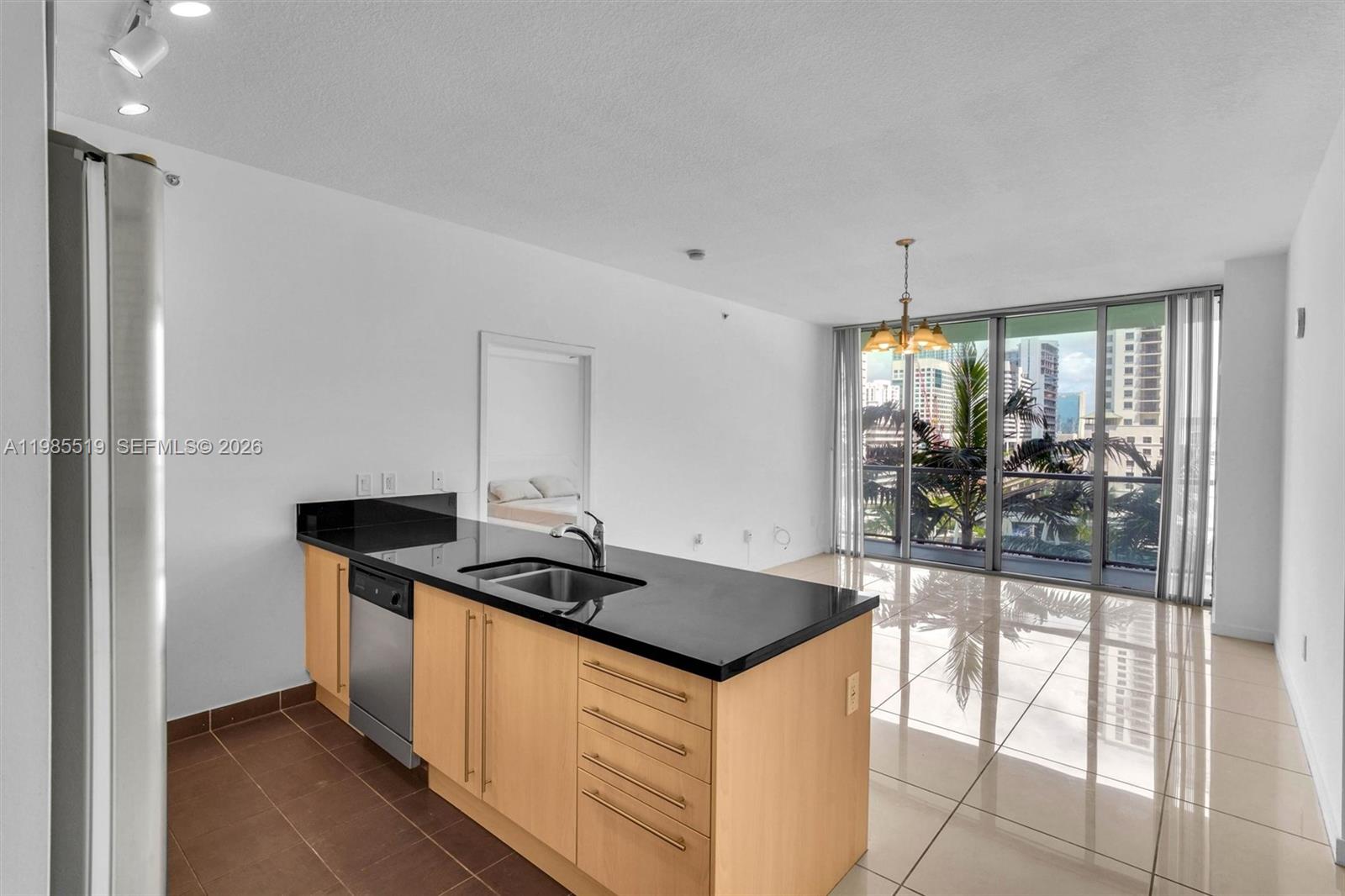 79 Southwest 12th Street, Unit 1210 Miami, FL 33130 - Photo 5 of 37 a kitchen that has a sink and a stove with granite countertops