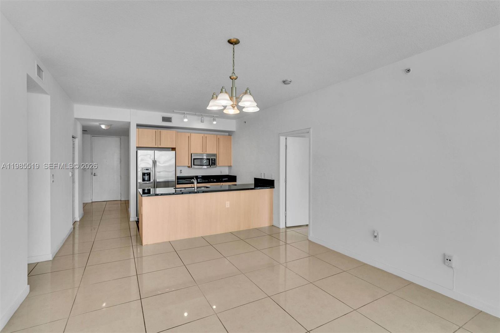 79 Southwest 12th Street, Unit 1210 Miami, FL 33130 - Photo 6 of 37 a large white kitchen with a sink and dishwasher a refrigerator with white cabinets