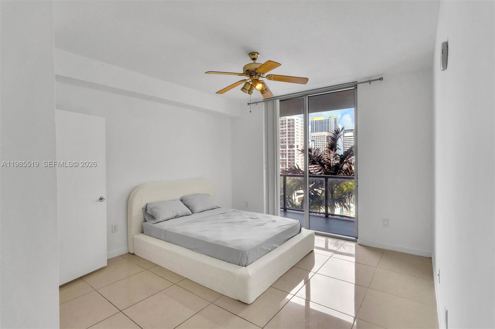 79 Southwest 12th Street, Unit 1210 Miami, FL 33130 - Photo 10 of 37 a bedroom with a bed and chandelier