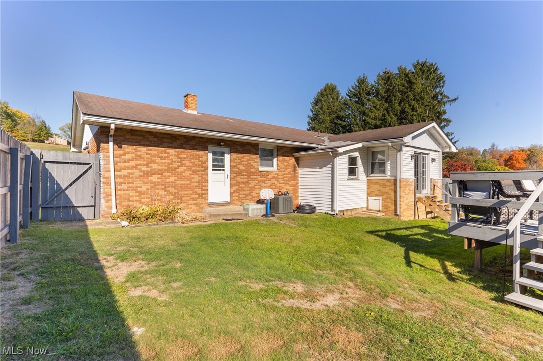 1230 Parshall Road Wellsville, OH 43968 - Photo 42 of 42 Rear view of property featuring central AC, a lawn, and a wooden deck