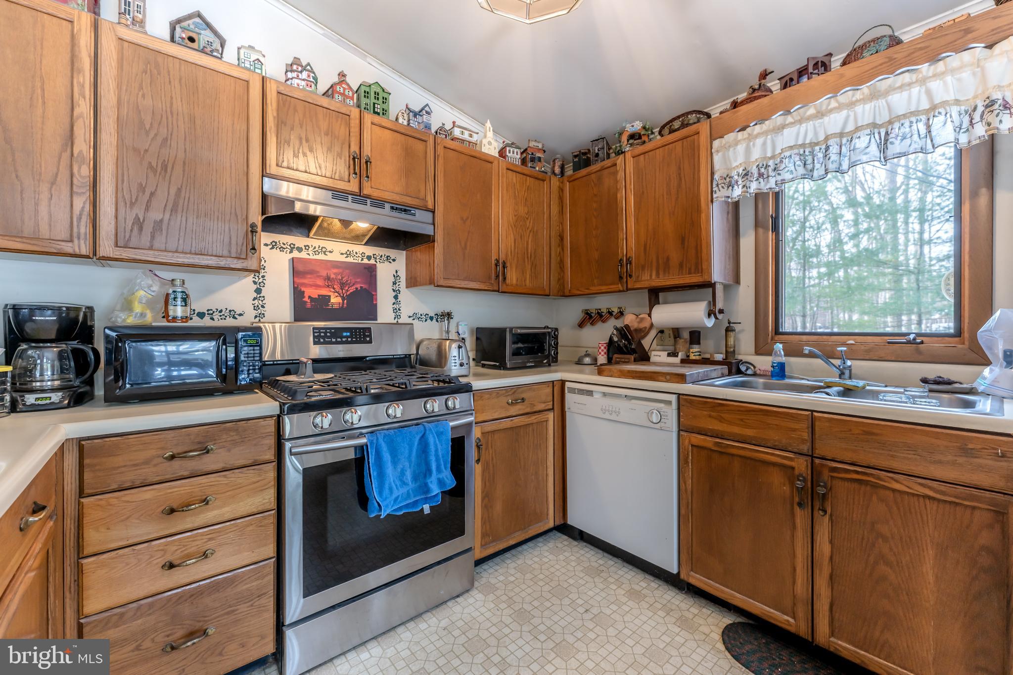 415 White Oak Road Lehighton, PA 18235 - Photo 8 of 45 a kitchen with stainless steel appliances granite countertop a sink a stove and a refrigerator