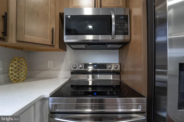 a kitchen with stainless steel appliances granite countertop a stove and a microwave