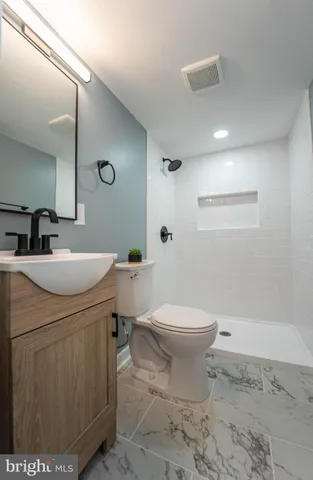 a bathroom with a sink toilet and shower