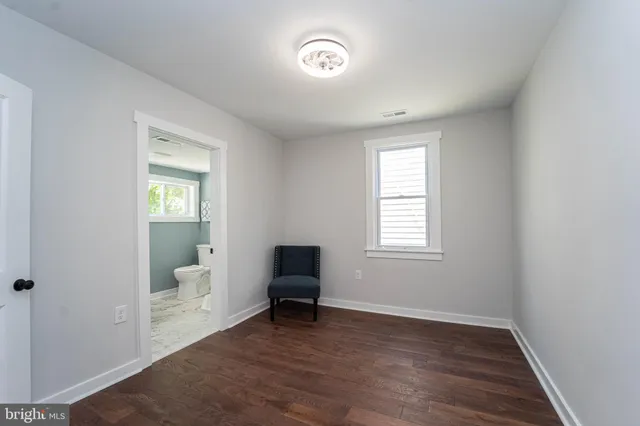 a view of a room with wooden floor and a window