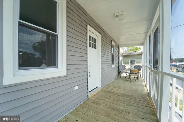 a view of a balcony with chairs and wooden floor