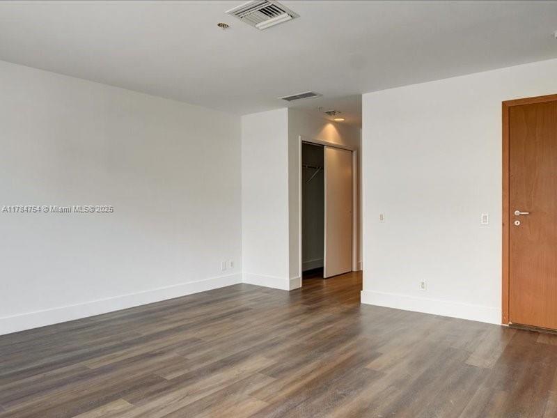 9499 Collins Avenue, Unit PH03 Surfside, FL 33154 - Photo 19 of 82 a view of an empty room with wooden floor