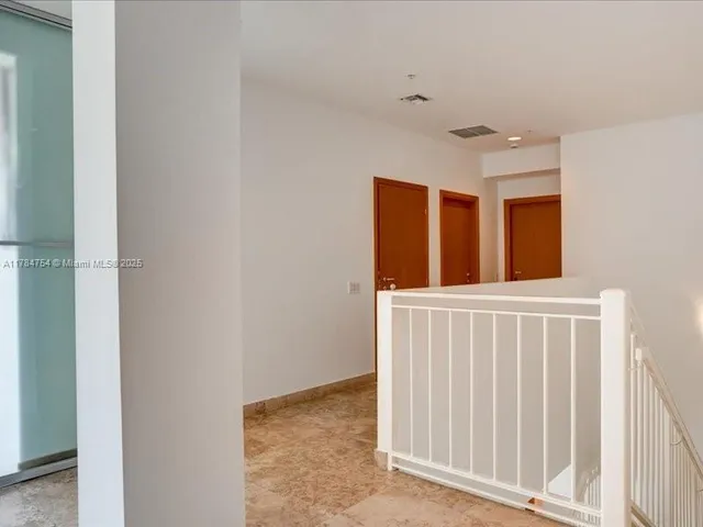 a view of a room with wooden floor and windows