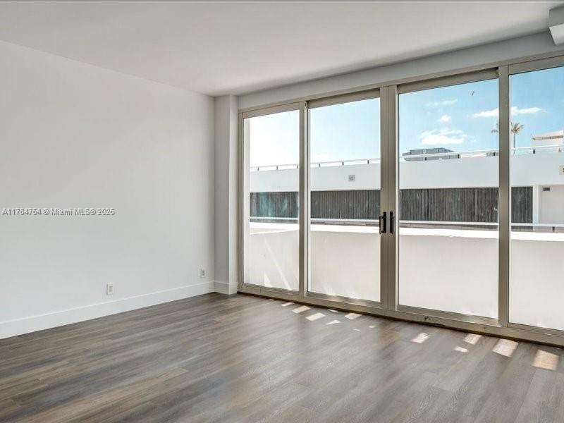 9499 Collins Avenue, Unit PH03 Surfside, FL 33154 - Photo 27 of 82 an empty room with wooden floor and window